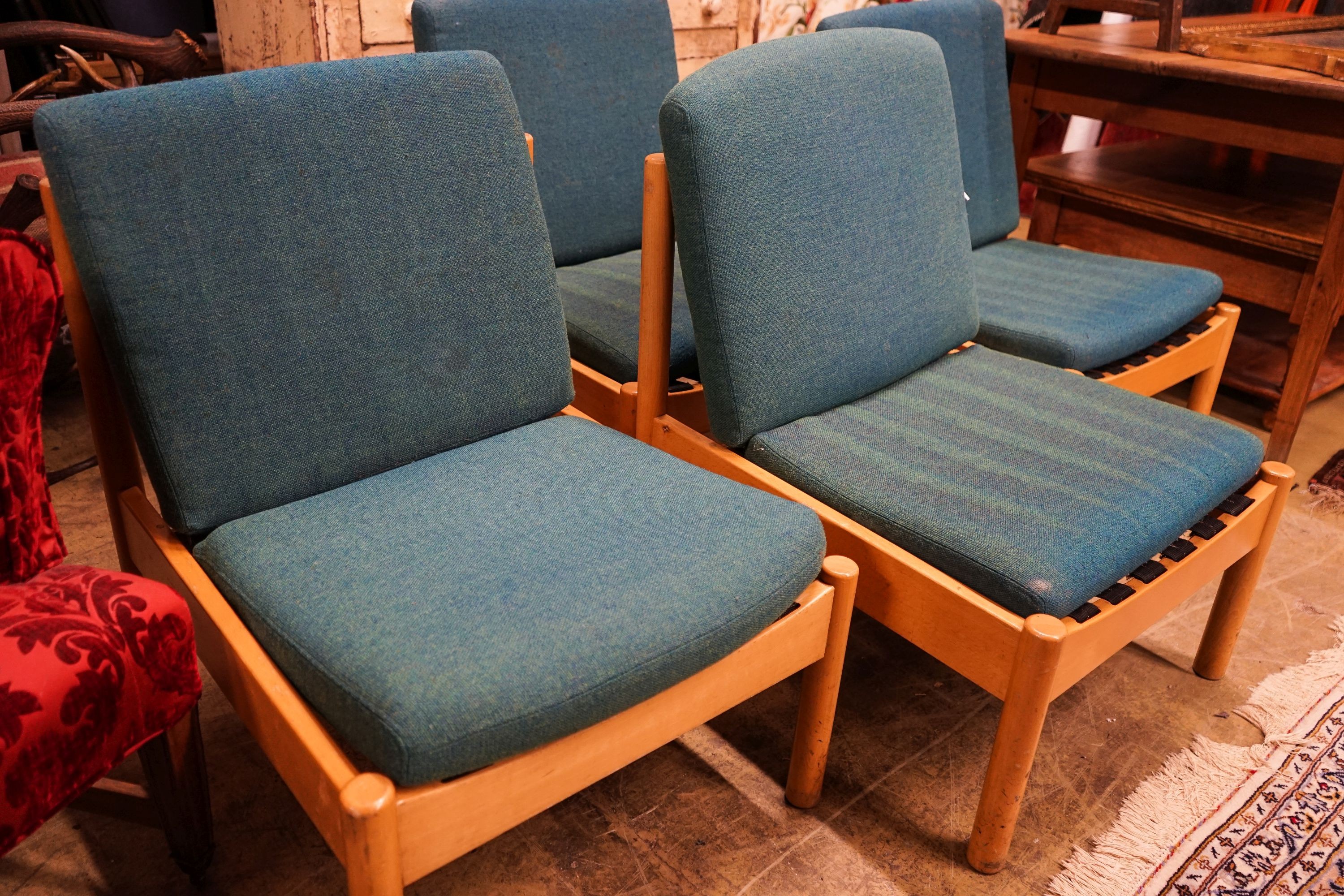 A set of four Ercol pale beech lounge chairs with cushion seats and backs, width 60cm, depth 66cm, height 82cm